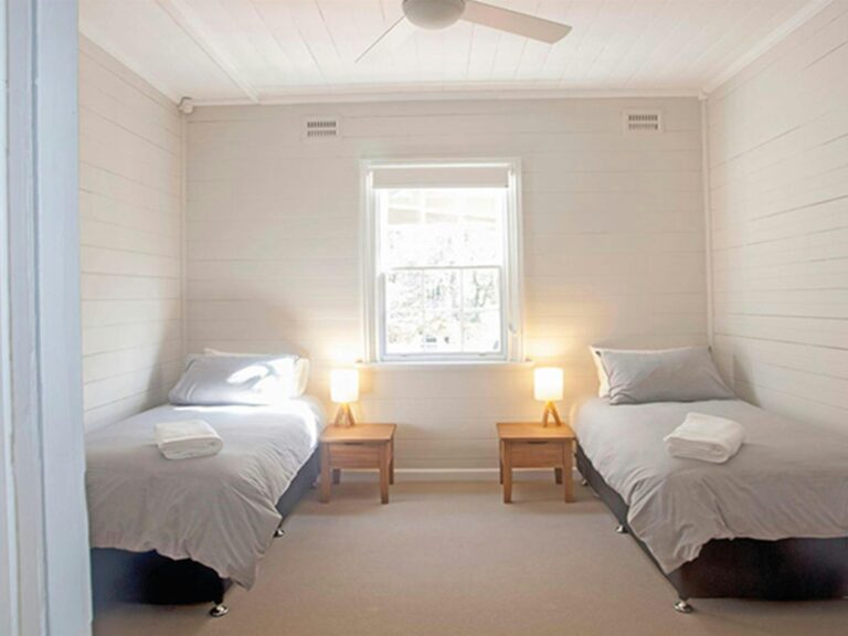 A bedroom with 2 single beds in Reids Flat Cottage, Royal National Park. Photo: Rosie Nicolai/DPIE