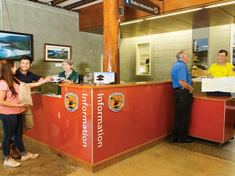 NPWS staff and visitors at the information desk in Royal National Park Visitor Centre, Royal