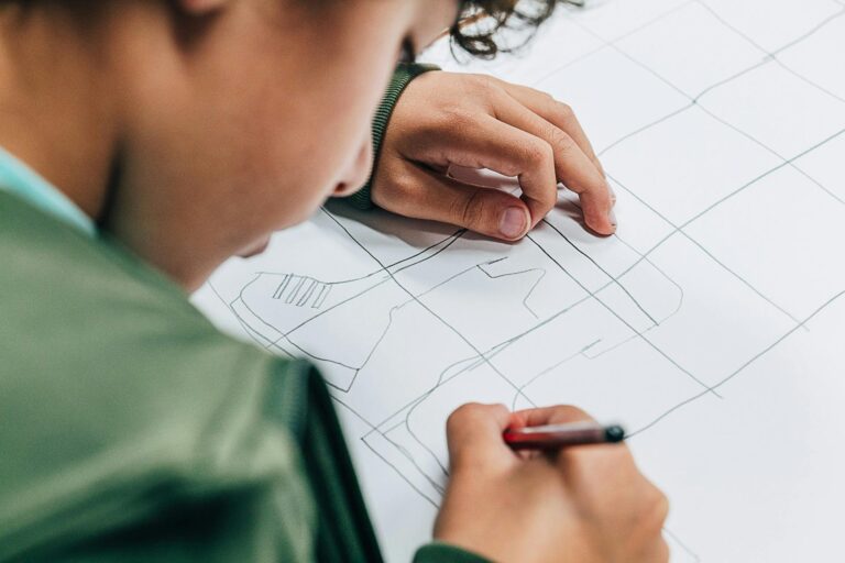 School aged boy drawing