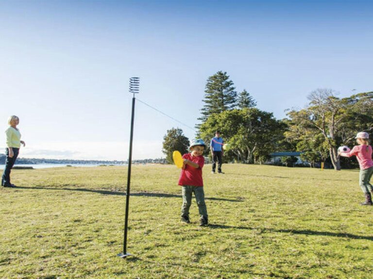 A family playing ball games on the grass at Bonnie Vale picnic area in Royal National Park. Photo: