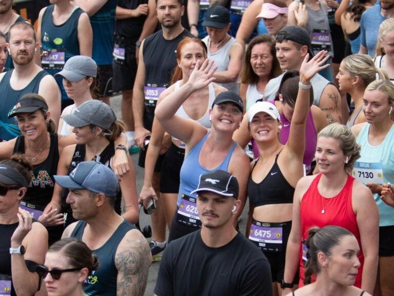 People waving at the start of a running race