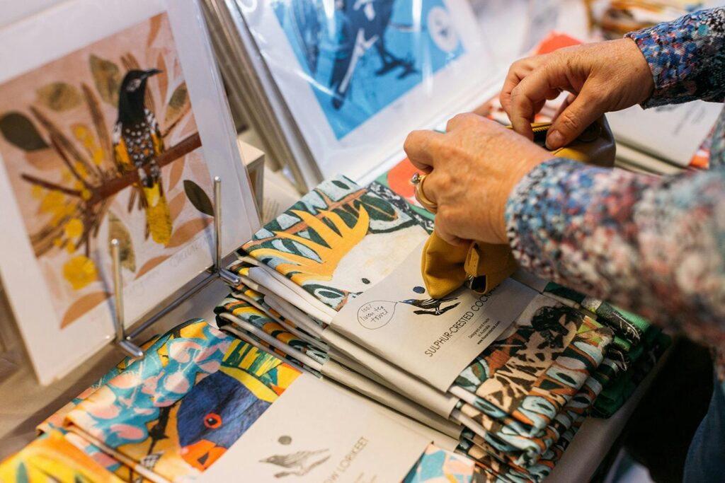 Person looking at goods featuring illustrations of Australian animals.