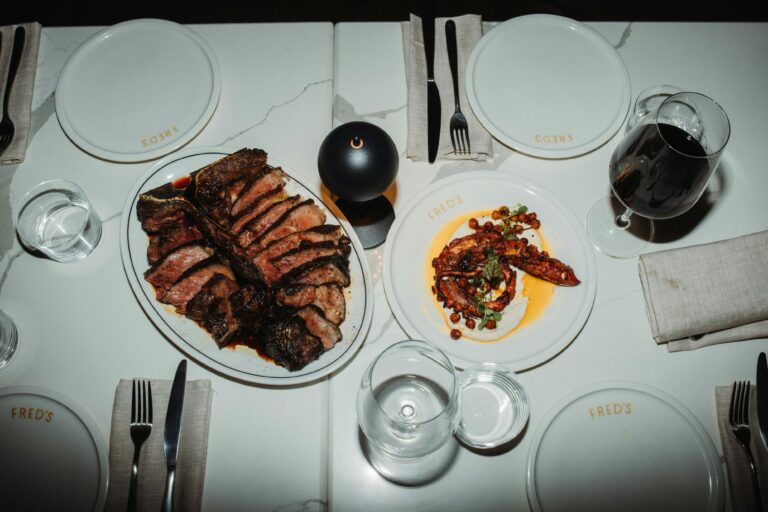 A Bistecca on a plate and octopus on a plate and dining table set