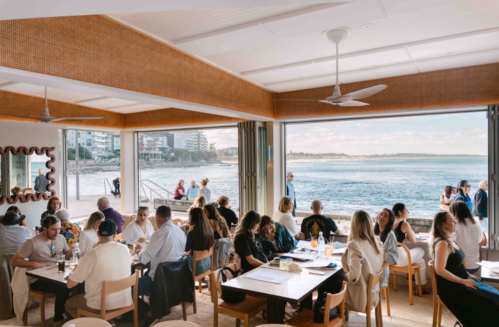 people dining with ocean view in the background