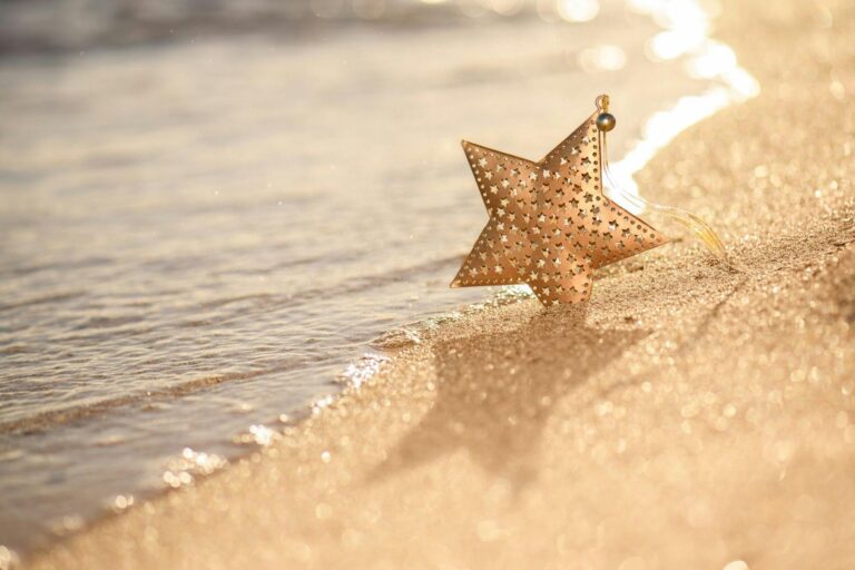 Christmas star decoration on a sandy beach
