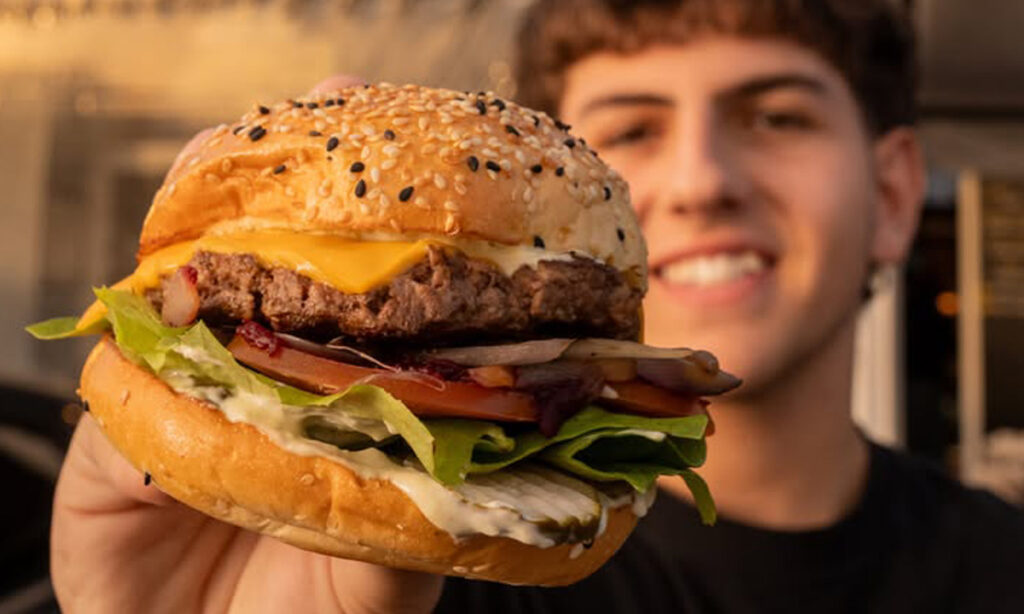 A man holding a hamburger