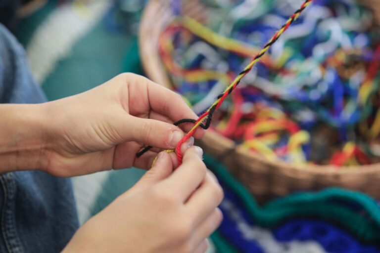 A person weaving twine at NAIDOC