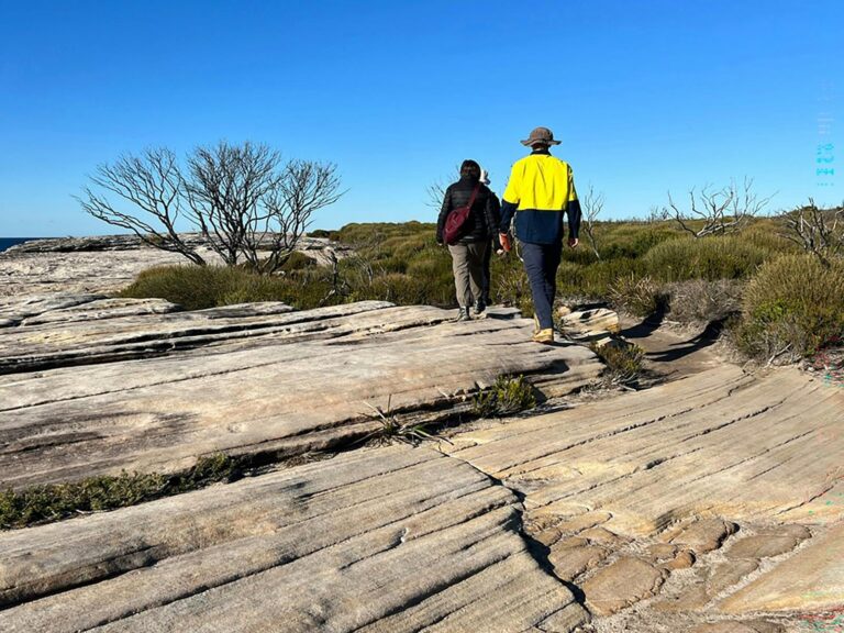 Two people walking the Cape Baily Coast Walk