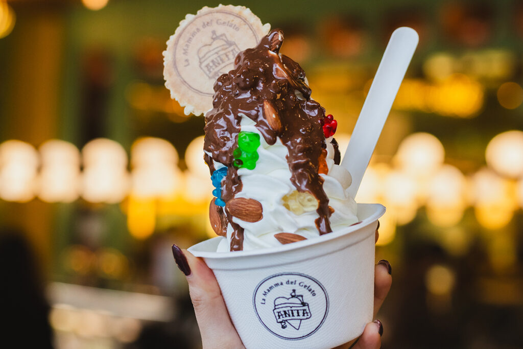 Hand holding gelato ice cream in a cup