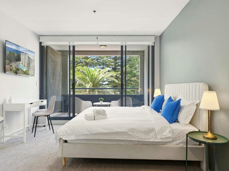 Bright bedroom with large window and balcony access