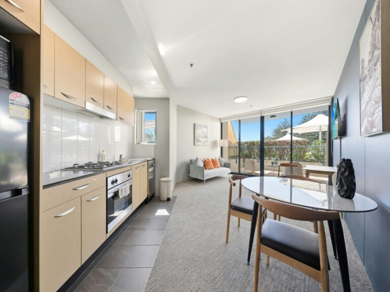 Modern kitchen with dining and balcony view